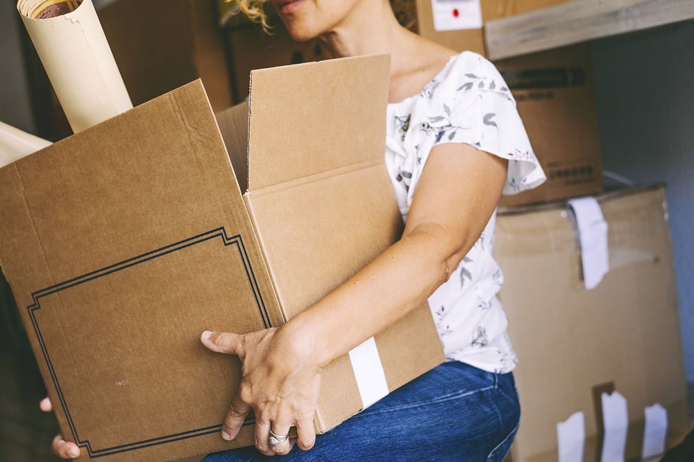 unrecognizable-woman-holding-big-carton-box-packag-2023-11-27-05-31-48-utc